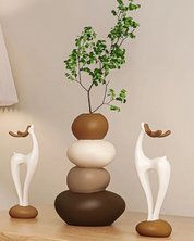 Conjunto de vasos decorativos sob a mesa e perto da parede com planta dentro