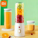 Liquidificador Portátil com laranja e suco de laranla perto